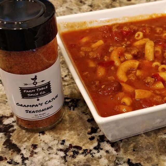 Grandpa's Cajun Seasoning next to a bowl of chili mac