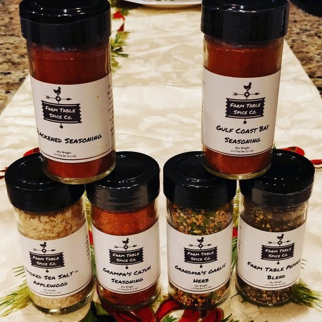 Six jars of Farm Table Spice Co. seasonings on a holiday table