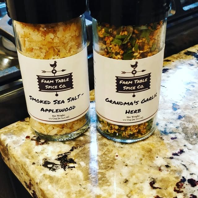 Smoked Sea Salt and Grandma's Garlic Herb jars on a granite counter